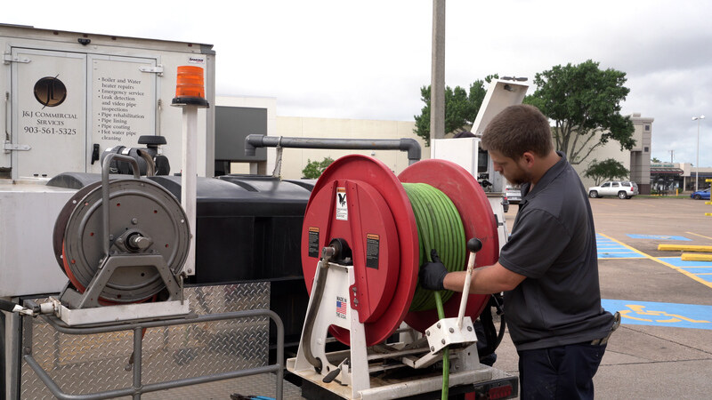 plumber preparing for hydro jetting drain cleaning service