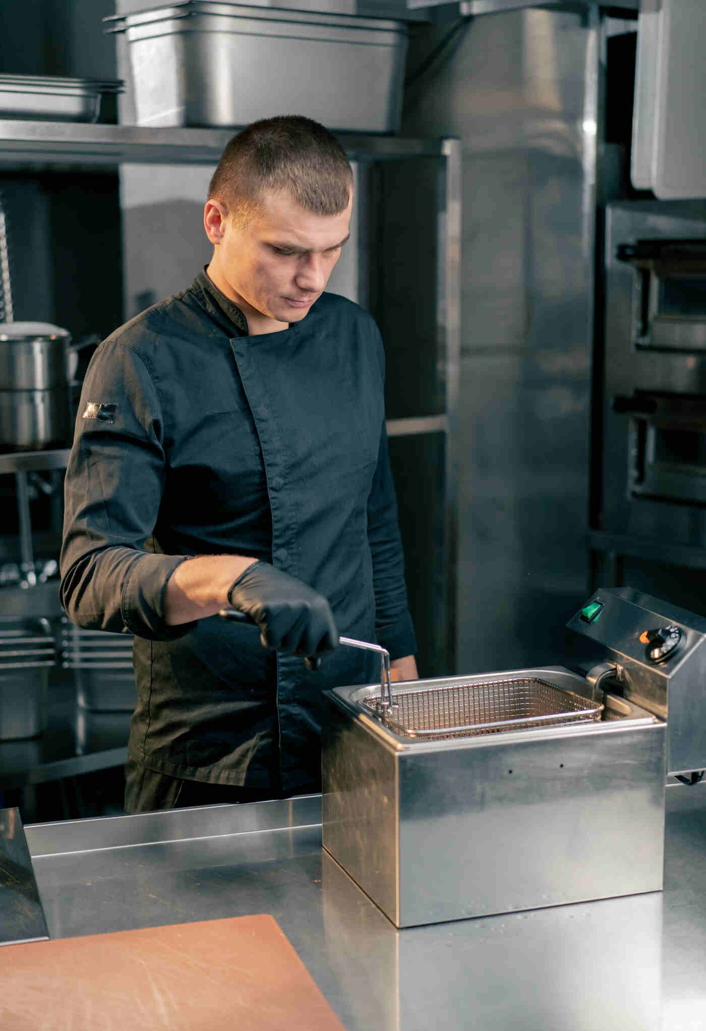 chef using a deep fryer