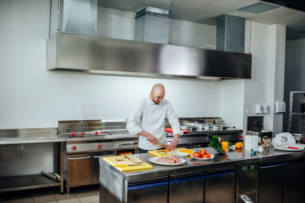 chef prepping food in ventilated kitchen