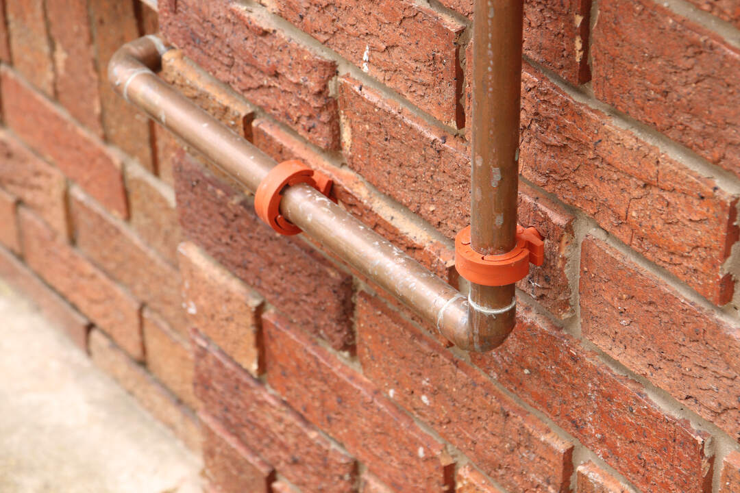 gas piping on brick wall