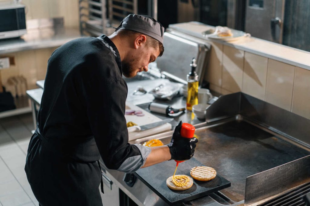 chef cooking on a flat top in a restaurant