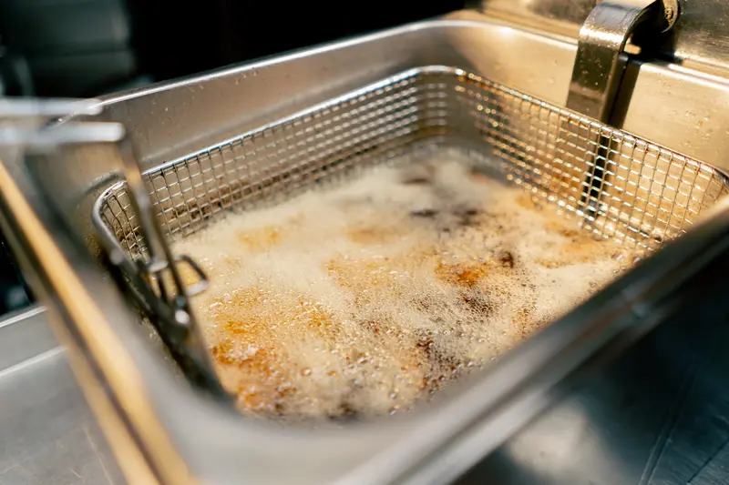 hot bubbling fryer in restaurant kitchen