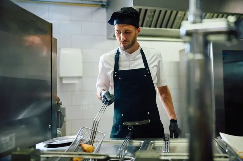 restaurant chef using hot side fryer
