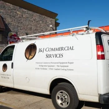 a white company vehicle with the J&J Commercial Services logo