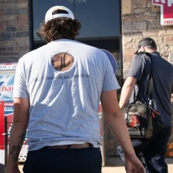 J&J Commercial Services workers in front of a building